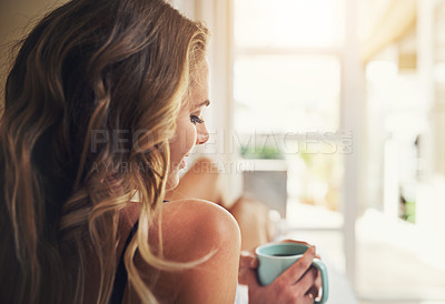 Buy stock photo Shot of a relaxed young woman having coffee at home