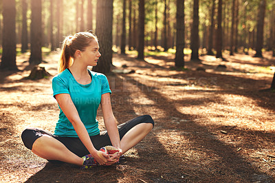 Buy stock photo Shot of a sporty young woman spending the day out in nature