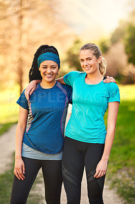 Buy stock photo Shot of two sporty young women out exercising in nature