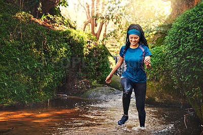 Buy stock photo Shot of a sporty young running through a stream of water in nature