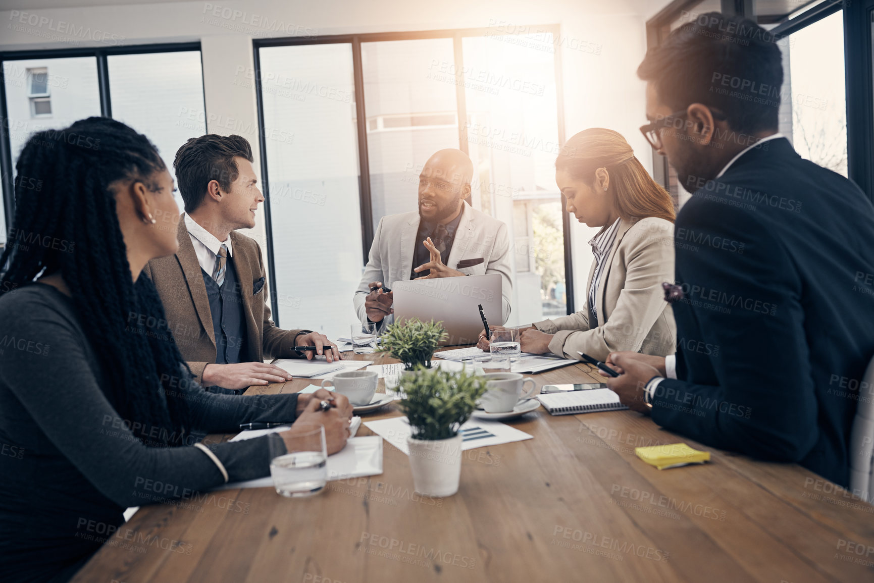 Buy stock photo Shot of a group of young businesspeople having a meeting in a modern office