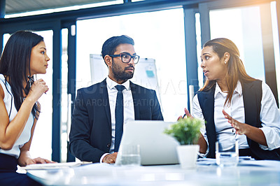 Buy stock photo Cropped shot of a group of young businesspeople having a discussion while working in a modern office