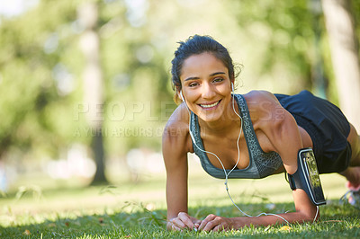 Buy stock photo Shot of a beautiful young woman exercising outdoors on a sunny day