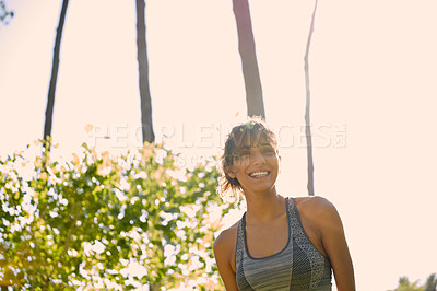 Buy stock photo Cropped shot of a sporty young woman standing outside on a sunny day