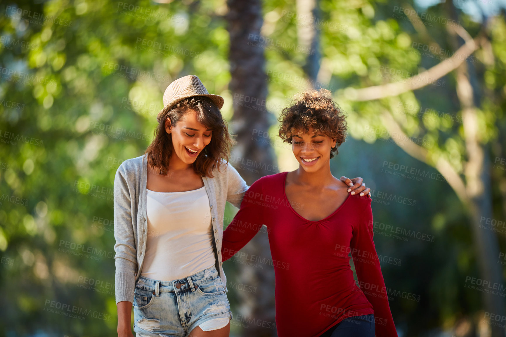 Buy stock photo Cropped shot of a young couple spending the day outdoors on a sunny day