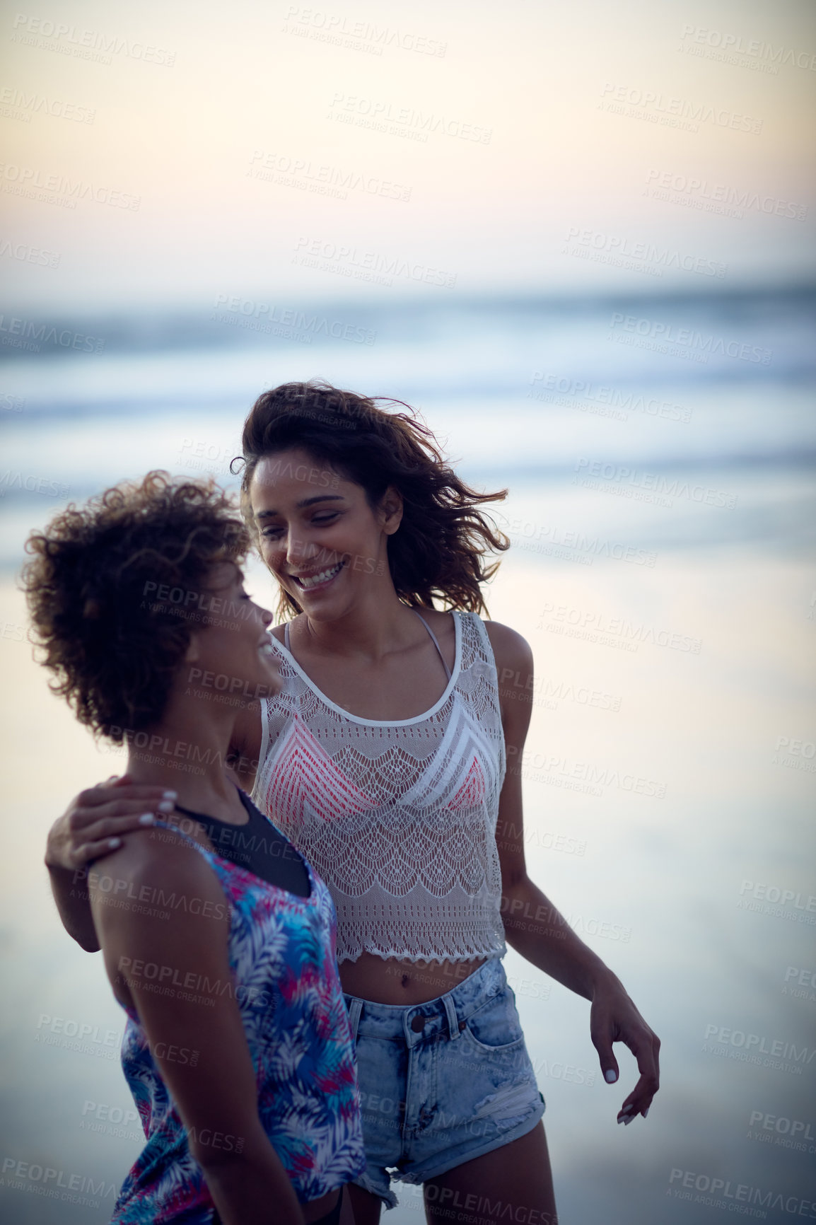Buy stock photo Shot of two young women enjoying themselves at the beach