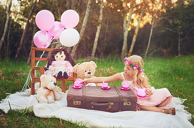 Buy stock photo Shot of an adorable little dressed as a princess having a teat party with her stuffed toys in the garden