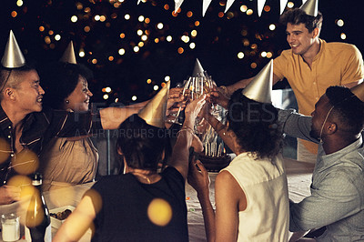 Buy stock photo Night, friends and birthday cheers with rooftop party, celebration and alcohol on a balcony with drinks. Social, champagne and toast with glass, lights and young people together with smile and fun