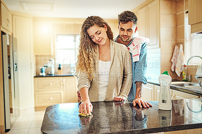 Buy stock photo Cropped shot of a young couple cleaning their house together