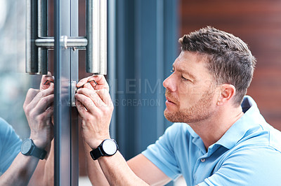 Buy stock photo Door, locksmith and man at a house for home renovation, repair and diy lock, change or installation. Safety, maintenance and male handyman person checking keyhole for security or entrance inspection