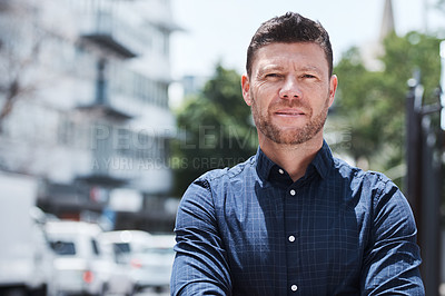 Buy stock photo Portrait of a handsome mature businessman standing outside in the city