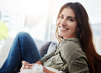 Buy stock photo Shot of a beautiful young woman relaxing in the sofa at home