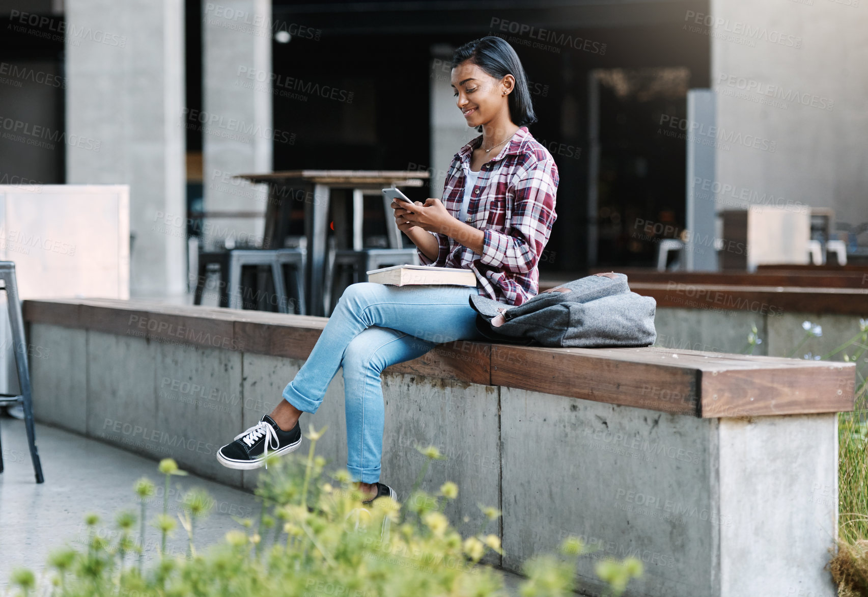 Buy stock photo Girl, university student and smartphone with book, outdoor and education with smile for walking at campus. Indian person, happy and phone with backpack, texting and chat on social media at college