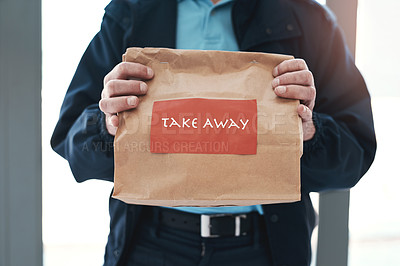 Buy stock photo Shot of an unrecognizable delivery man holding a restaurant takeaway