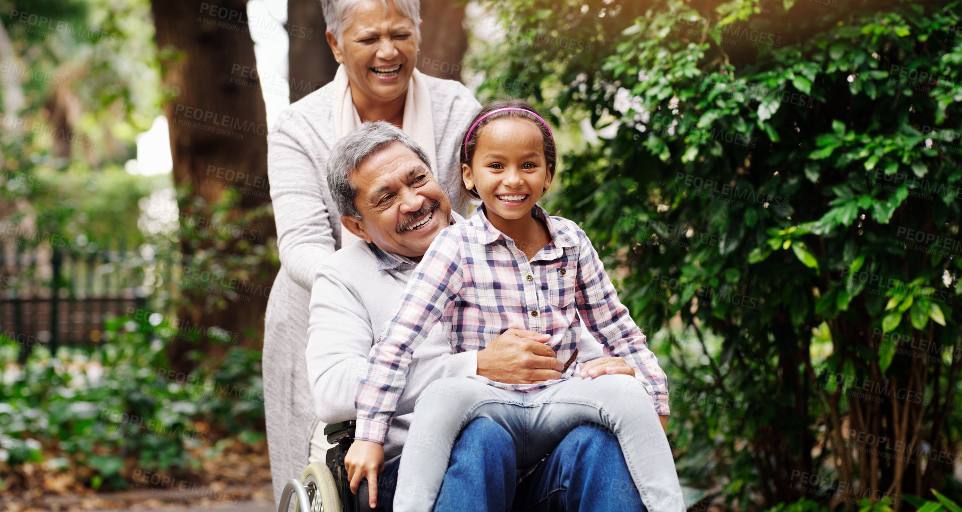 Buy stock photo Grandparents, park and a senior man in a wheelchair together with his wife and adorable granddaughter. Person with a disability, love or time with a happy girl child and her mature family in a garden