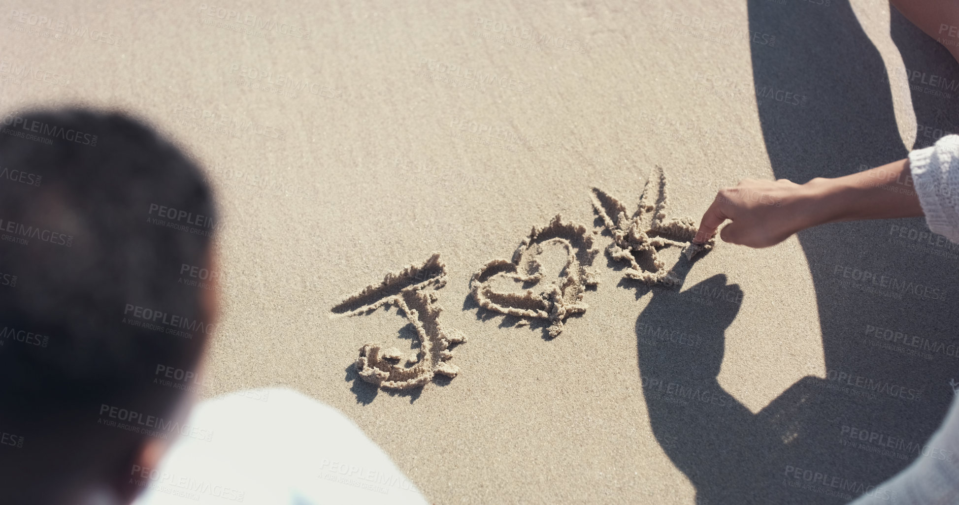 Buy stock photo Hands, couple and writing in sand at beach with heart, letters and bonding on vacation in summer. People, notes or text on ground for connection, love and care with symbol, icon or emoji on holiday