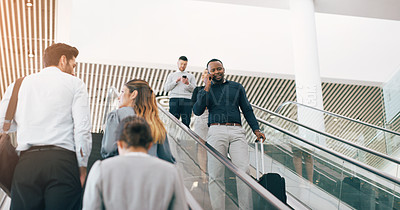 Buy stock photo Cropped shot of a handsome young businessman taking a phonecall while going down an escalator in a modern workplace