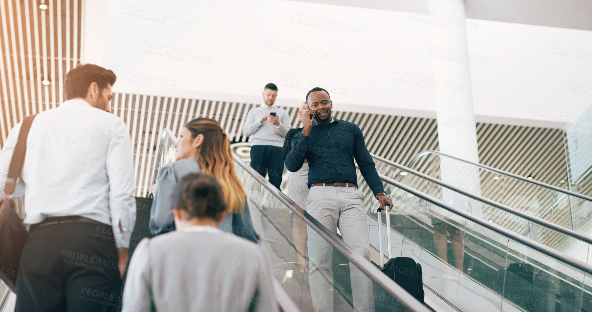 Buy stock photo Businessman, escalator and talking with phone call for discussion or communication on work trip. Black man speaking on mobile smartphone in travel with luggage for immigration or new opportunity