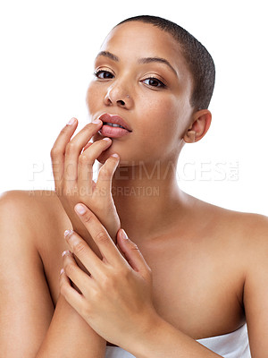 Buy stock photo Portrait of a beautiful young woman touching her lips while standing against a white background