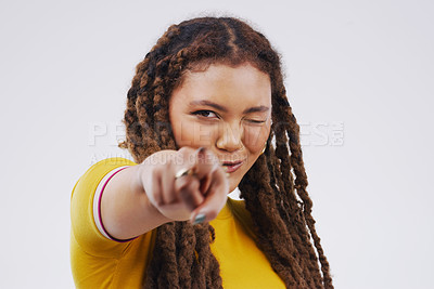 Buy stock photo Portrait, wink and woman pointing at you in studio for decision, selection and face isolated on a white background mockup space. Direction, choice or hand gesture for opportunity, success or flirt