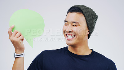 Buy stock photo Young asian man, speech bubble and studio with smile, opinion and social media with by background. Gen z guy, poster or paper sign for vote, review or mockup with happiness for ideas, news or chat
