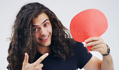 Buy stock photo Man, speech bubble and pointing in studio portrait for smile, opinion or social media by white background. Gen z guy, poster or paper sign for vote, review or mockup with point for idea, news or chat