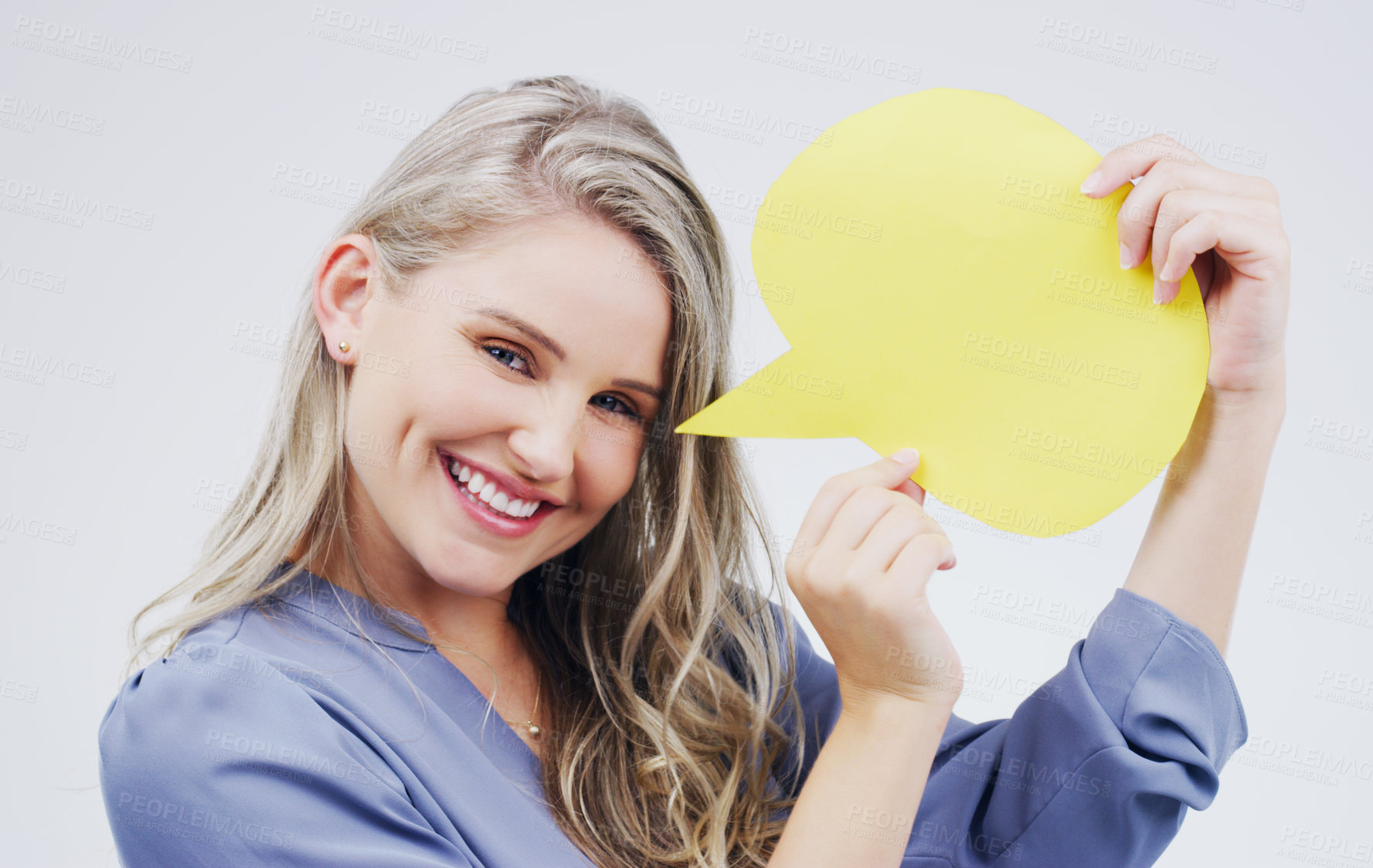 Buy stock photo Portrait of an attractive young woman holding a speech bubble against a grey background