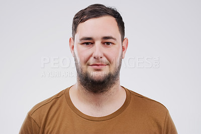 Buy stock photo Studio portrait of a handsome young man smiling against a grey background