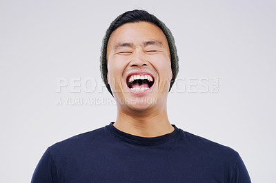 Buy stock photo Happy, laughing and man in studio with a casual outfit excited for a comic joke or funny story. Happiness, smile and face of an Asian male person with a positive facial expression by white background