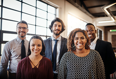 Buy stock photo Cropped portrait of a diverse team of happy businesspeople posing together in their office