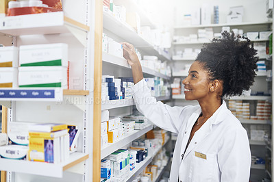 Buy stock photo Cropped shot of a female pharmacist taking a product from the shelves