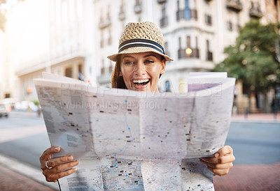Buy stock photo Cropped shot of an attractive young woman looking at a map while touring a foreign city