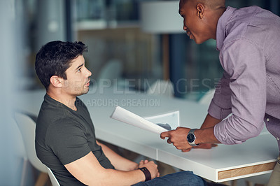 Buy stock photo Shot of a young businessman being reprimanded by a colleague in a modern office