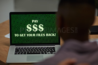 Buy stock photo Shot of a businessman using a laptop with the words “pay $$$ to get your files back” on the screen