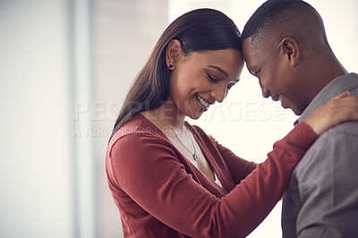 Buy stock photo Shot of a happy young couple sharing a romantic moment together