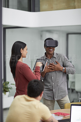 Buy stock photo Shot of a group of young businesspeople using a digital tablet and a virtual reality headset during a meeting