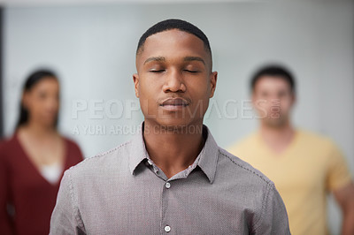 Buy stock photo Shot of a group of young businesspeople standing in a modern office with their eyes closed