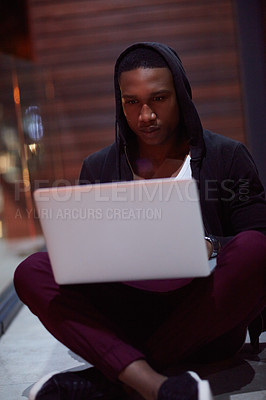 Buy stock photo Shot of a young hacker using a laptop