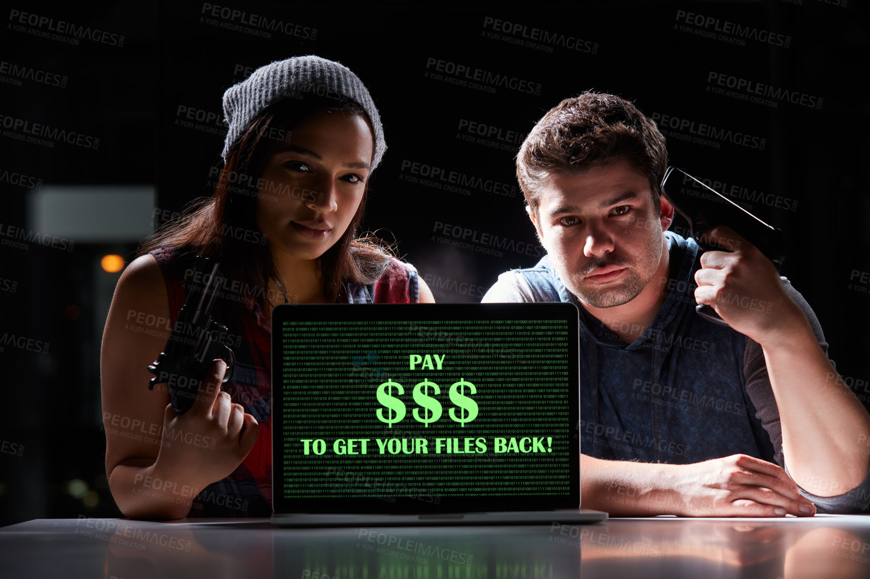 Buy stock photo Shot of two armed hackers using a laptop with “Pay $$$ to get your files back” on it