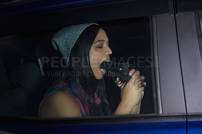 Buy stock photo Shot of a young woman sitting in a car and pointing a gun into her mouth