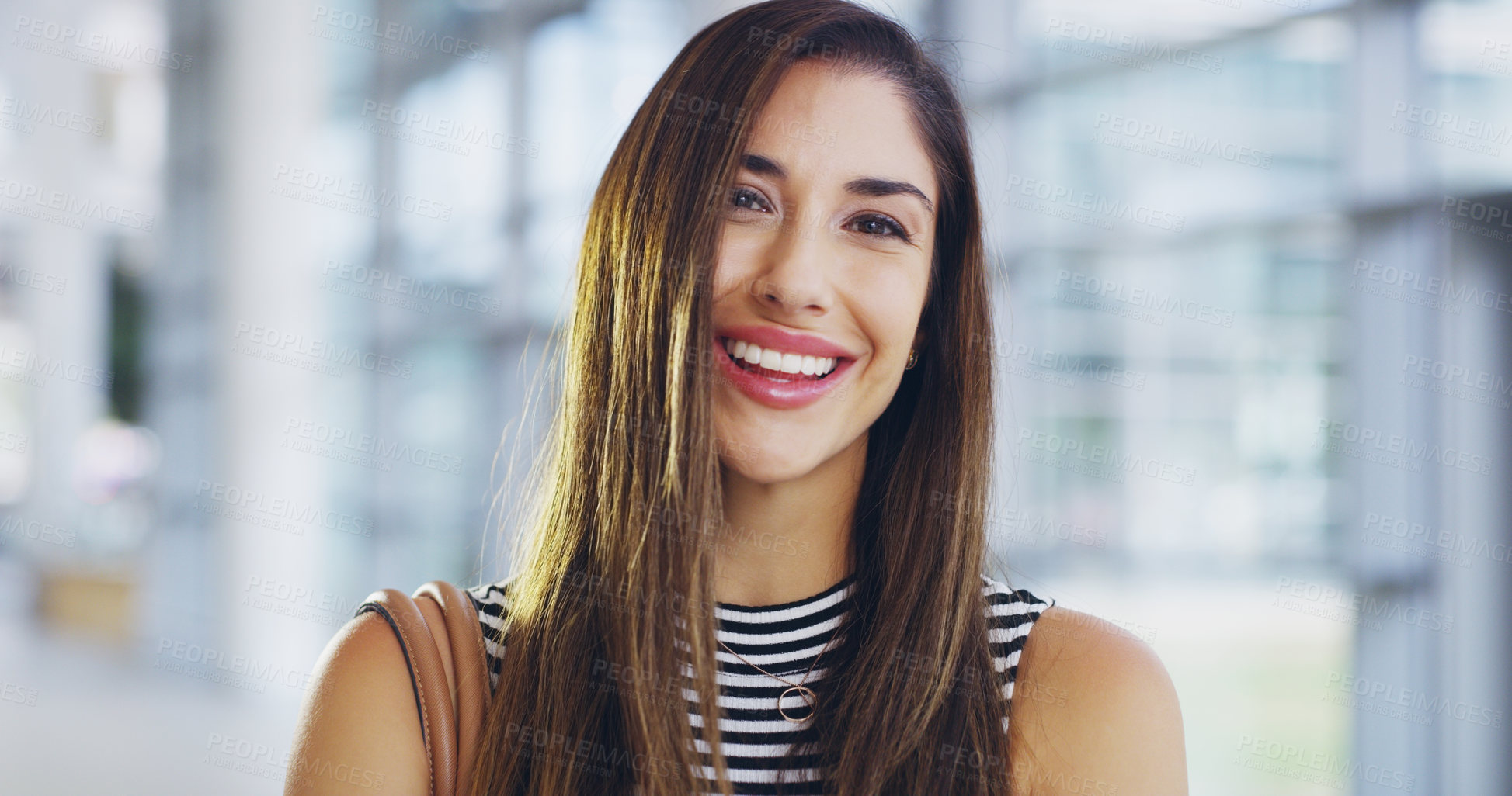 Buy stock photo Cropped shot of a confident young businesswoman walking through a modern office