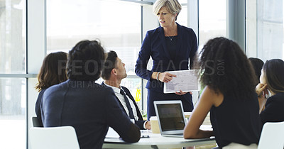 Buy stock photo Cropped shot of a businesswoman using a digital tablet while giving a presentation to her colleagues in a modern office