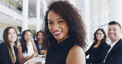 Buy stock photo Cropped shot of a young businesswoman smiling in an office during a meeting with her colleagues in the background