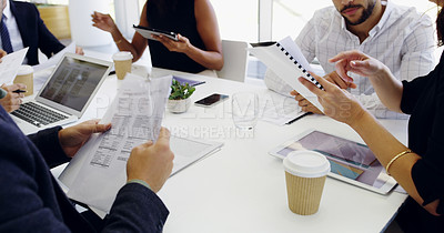 Buy stock photo Cropped shot of a group of businesspeople sitting around the boardroom table during a meeting
