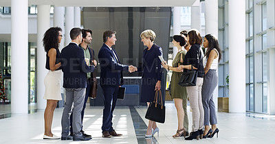 Buy stock photo Full length shot of two businesspeople shaking hands during a meet and greet