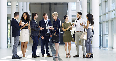 Buy stock photo Full length shot of a group of businesspeople standing and talking in the workplace