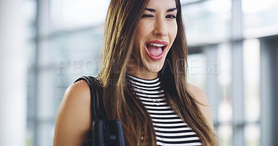 Buy stock photo Cropped shot of an attractive young businesswoman winking while walking through a modern office
