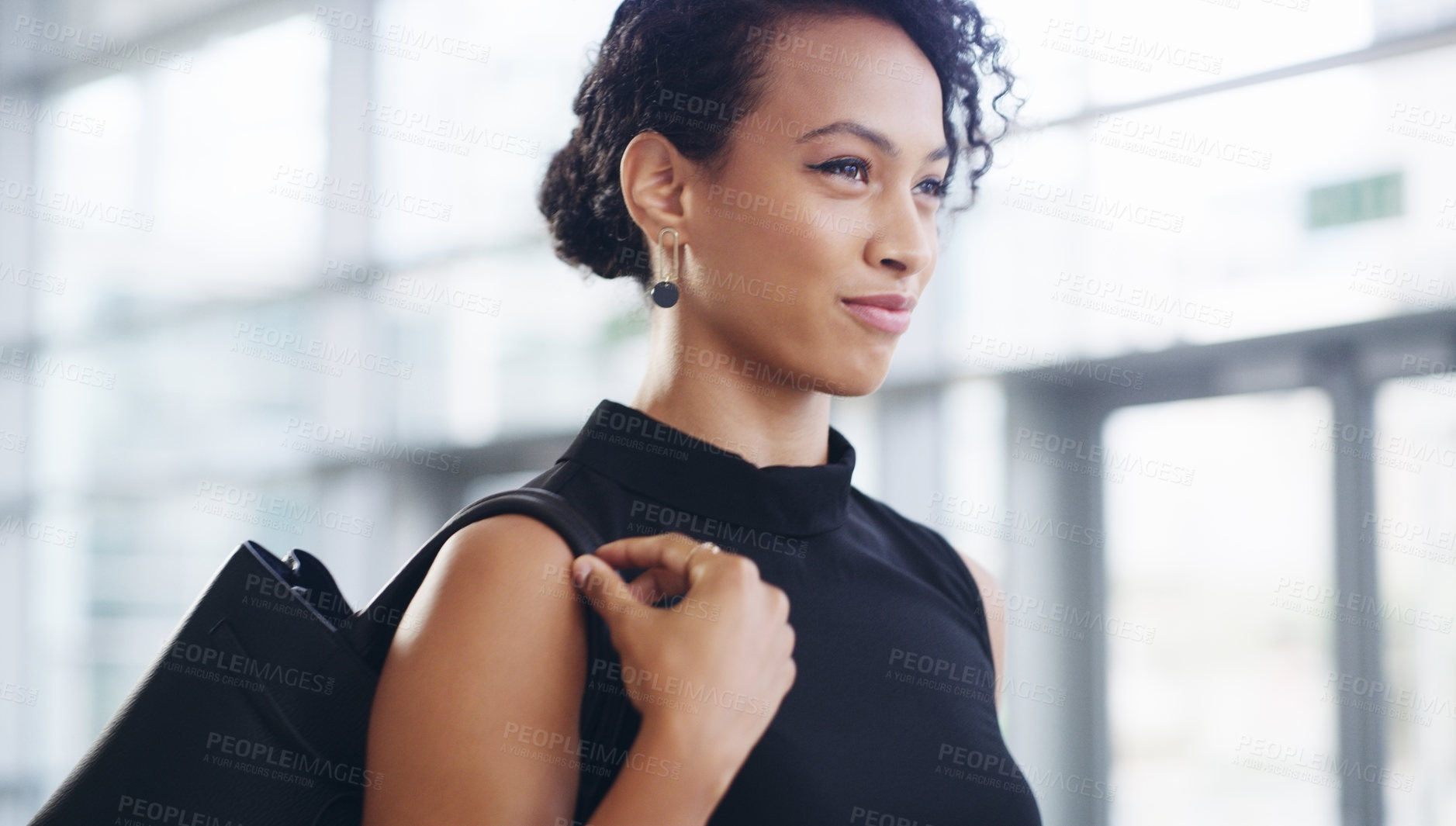 Buy stock photo Cropped shot of a confident young businesswoman walking through a modern office