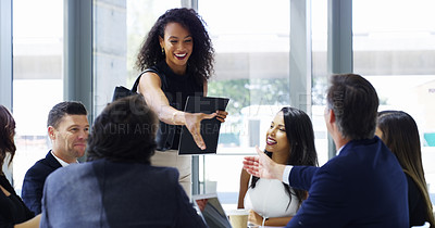 Buy stock photo Cropped shot of a businesswoman shaking hands with colleagues during a meeting in an office