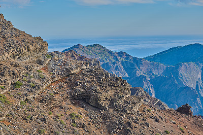 Buy stock photo Mountains, volcano and outdoor in nature, sky and island with geology, rocks and summer in environment. Cliff, stone and sunshine on hill with landscape, trekking and tourism in La Palma, Spain